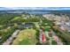 Aerial view of a home on a golf course near a pond and lake, with residential streets at 3018 Andover Ct, Mount Dora, FL 32757