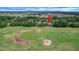 Aerial view of a home situated on a golf course with lush green fairways and sand traps at 3018 Andover Ct, Mount Dora, FL 32757