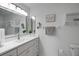 Clean, modern bathroom featuring a stylish vanity, framed mirror, and coordinated decor at 3018 Andover Ct, Mount Dora, FL 32757
