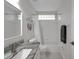 Bathroom with granite countertop, white cabinets, shower-tub combo and decor at 3018 Andover Ct, Mount Dora, FL 32757