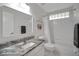 Bathroom with granite countertop, white cabinets, and shower-tub combo at 3018 Andover Ct, Mount Dora, FL 32757