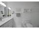 Modern bathroom with white cabinets, stainless steel hardware, and decorative accents at 3018 Andover Ct, Mount Dora, FL 32757
