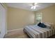 Bedroom with light hardwood floors, ceiling fan and a window view at 3018 Andover Ct, Mount Dora, FL 32757