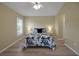 Bright bedroom featuring wood floors, ceiling fan, and a window with shutter-style blinds at 3018 Andover Ct, Mount Dora, FL 32757