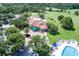 Exterior shot of the clubhouse featuring beautiful landscaping and ample parking at 3018 Andover Ct, Mount Dora, FL 32757