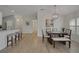 Open-concept dining room and kitchen featuring a modern chandelier and sleek countertops at 3018 Andover Ct, Mount Dora, FL 32757
