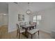 Bright dining room featuring a chandelier, modern window, and an elegant wooden table with chairs at 3018 Andover Ct, Mount Dora, FL 32757
