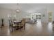Dining area featuring modern chandelier lighting and hardwood floors at 3018 Andover Ct, Mount Dora, FL 32757