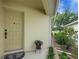 Charming front porch with a potted plant and a well-manicured garden bed at 3018 Andover Ct, Mount Dora, FL 32757