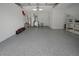Spacious garage with epoxy floors, ample storage, and overhead lighting at 3018 Andover Ct, Mount Dora, FL 32757