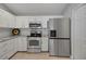 Well-equipped kitchen with white cabinets, modern appliances, and ample counter space at 3018 Andover Ct, Mount Dora, FL 32757