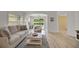 Comfortable living room featuring a cozy sofa, a neutral armchair, and sliding doors to a patio at 3018 Andover Ct, Mount Dora, FL 32757