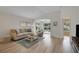 Inviting living room with a comfortable sofa, a neutral area rug, and sliding doors to the outdoors at 3018 Andover Ct, Mount Dora, FL 32757