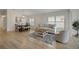 Open-concept living space with modern decor, dining area, and light wood floors at 3018 Andover Ct, Mount Dora, FL 32757