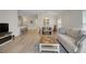 Bright open living space featuring a dining area, seating, and wood flooring throughout the area at 3018 Andover Ct, Mount Dora, FL 32757