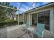 Outdoor seating on a screened-in patio with a view of the neighborhood landscaping at 3018 Andover Ct, Mount Dora, FL 32757
