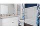 Bathroom with a tub-shower combo, white vanity, and blue patterned shower curtain at 3121 Partington Blvd, Davenport, FL 33837