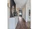 Inviting hallway with wood floors, decorative console table, and stylish lighting at 3121 Partington Blvd, Davenport, FL 33837