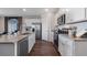 Bright kitchen featuring white cabinetry, stainless appliances, and quartz countertops at 3121 Partington Blvd, Davenport, FL 33837