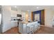 Stylish kitchen featuring white cabinets, a breakfast bar and stainless steel appliances at 3121 Partington Blvd, Davenport, FL 33837