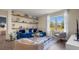 Cozy living room with large windows, comfortable seating, and decorative shelving at 3121 Partington Blvd, Davenport, FL 33837