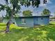 Image of the backyard featuring a grassy lawn and the back of the property at 3220 Mahalia Pl, Orlando, FL 32805