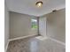 Neutral bedroom with a closet, tile flooring, and natural light from the window at 3220 Mahalia Pl, Orlando, FL 32805