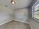 This bedroom includes tile floors, neutral walls, one window and a ceiling light fixture at 3220 Mahalia Pl, Orlando, FL 32805