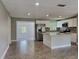 Spacious kitchen with island, stainless steel appliances, and open layout into the living area at 3220 Mahalia Pl, Orlando, FL 32805