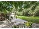 Backyard area featuring a patio with lounge chairs, lush grass, and gravel at 368 E Chelsea St, Deland, FL 32724
