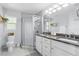 Bathroom featuring double sinks, granite countertops, and a tiled glass enclosed shower at 368 E Chelsea St, Deland, FL 32724