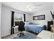 Comfortable bedroom with computer setup, ceiling fan, and bright window views at 368 E Chelsea St, Deland, FL 32724