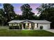 Charming single story home featuring a manicured lawn and lovely front porch seating area at 368 E Chelsea St, Deland, FL 32724