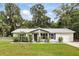 Charming single story home featuring a manicured lawn and lovely front porch seating area at 368 E Chelsea St, Deland, FL 32724