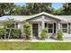 Close up front exterior view featuring manicured landscaping and a cozy front porch seating area at 368 E Chelsea St, Deland, FL 32724