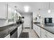 Well-lit kitchen features stainless steel appliances, granite countertops, and wood floors at 368 E Chelsea St, Deland, FL 32724