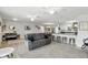 Bright living room flows into the kitchen featuring wood floors and gray sofa at 368 E Chelsea St, Deland, FL 32724