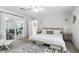 Airy main bedroom boasts sliding glass doors to patio and a decorative rug adding charm at 368 E Chelsea St, Deland, FL 32724