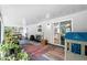 Covered patio featuring vibrant rugs, potted plants, seating and play area at 368 E Chelsea St, Deland, FL 32724