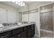 Bathroom features dual sinks, granite counters, and glass enclosed shower at 3806 Lana Ave, Davenport, FL 33897