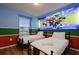 Bright bedroom with two twin beds, light wood floors and a themed mural at 3806 Lana Ave, Davenport, FL 33897