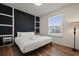 Modern bedroom with white linens, decorative wall accents, and a window providing natural light at 3806 Lana Ave, Davenport, FL 33897