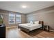 Comfortable bedroom with neutral tones, hardwood floors, natural light, and a modern television at 3806 Lana Ave, Davenport, FL 33897