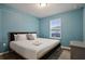 Comfortable bedroom features hardwood floors, closet, and a bed with many pillows and crisp, white linens at 3806 Lana Ave, Davenport, FL 33897