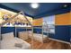 The blue Minions themed bedroom features twin beds with white bed frames and light wood floors at 3806 Lana Ave, Davenport, FL 33897
