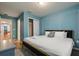 Bright bedroom features hardwood floors, closet, and a bed with many pillows and crisp, white linens at 3806 Lana Ave, Davenport, FL 33897
