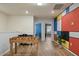 Spacious bonus room with foosball table, colorful wall art, and wood laminate flooring at 3806 Lana Ave, Davenport, FL 33897