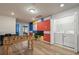 Bonus room featuring colorful accent wall, game table, laundry closet, and wood floors at 3806 Lana Ave, Davenport, FL 33897