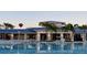 Exterior of clubhouse with palm trees, pool, lounge chairs, and colorful hot air balloon in the background at 3806 Lana Ave, Davenport, FL 33897