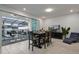 Bright dining area with seating for eight and sliding door access to an enclosed outdoor pool area at 3806 Lana Ave, Davenport, FL 33897
